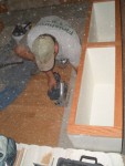 2005 August 29 Conversation Pit Installation 09 bench #2 trimming floor.jpg